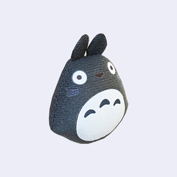 Dark gray plush magnet of Totoro from My Neighbor Totoro, with simplistic features and a blank expression.