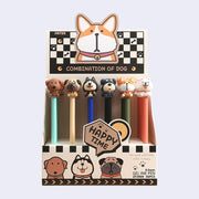 Set of 6 gel pens with different cartoon dogs as the pen toppers, each with an exaggerated, large head. Dogs are: corgi, pug, schnauzer, husky, chocolate lab and samoyed. In their display box.