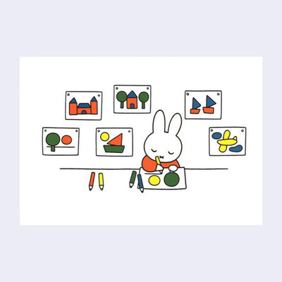 White postcard with an illustration of Miffy sitting at a desk and drawing with calm, closed eyes. Behind her, art is hung up on the wall.