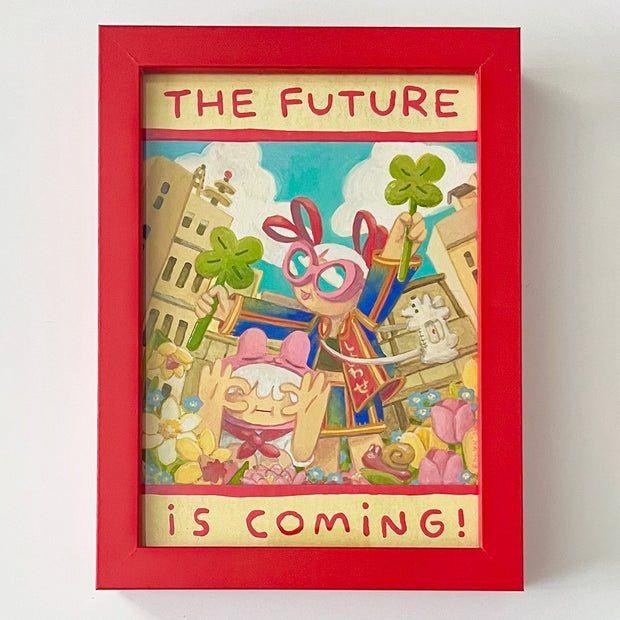 Painting of 2 cartoon style women standing in a field of flowers. One kneels and has her hands shaped to form a "c" over her face, the other stands and holds 2 four leaf clovers. Text around reads "The Future is Coming!" Piece is in thick red frame.