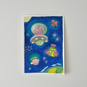 Painting of a blue starry sky with a pink bunny flying in a small space craft. Around are various planets: one shaped like a heart, one with wings and a halo and one blooming large flowers.