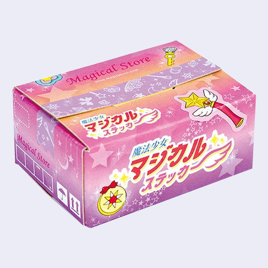 Small cardboard box made to look like a shipping package of colorful, magic girl themed items with Japanese writing and various wands and themed illustrations on the front.