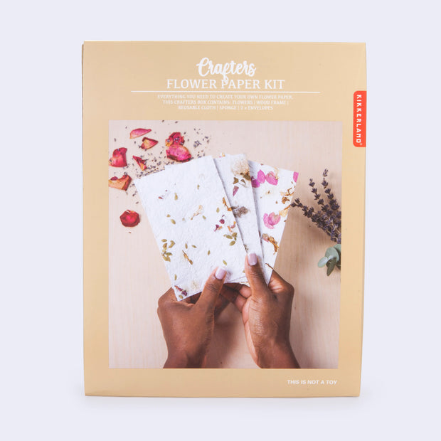 Product packaging of a kit to make your own paper with flower petals within the paper sheets.