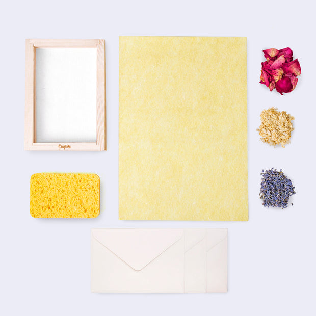 A kit to make your own paper with flower petals within the paper sheets.