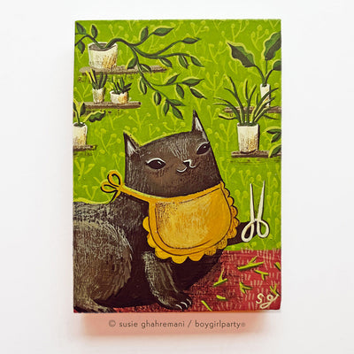 Painting on rectangular wood panel of a black cartoon cat wearing a yellow bib and holding shears, with several house plants on shelves behind.