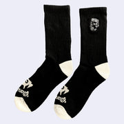 Black mid calf length socks with cream colored toes and heels and a small embroidery on the upper calf part of a robot carrying a flag that reads "Giant Robot."