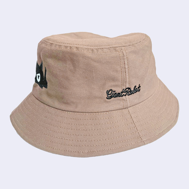 Light brown bucket hat with black embroidered text that reads "giant robot" in cursive.