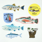 Set of 7 stickers, all illustrated in a similar style of fish, mostly salmon and trout.