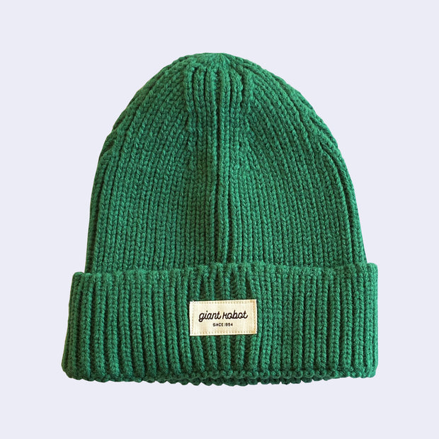 Knit beanie in a forest green color, with a small rectangle patch on the front that says "giant robot" and "since 1994" below in all caps.