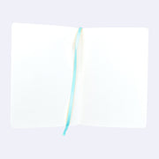 Open spread of blank sketchbook pages, with a blue place marker ribbon running down the center.