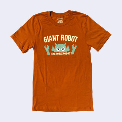 Burnt orage colored shirt with cream writing that reads "Giant Robot" above a mint colored boss robot. Text below its head and in between its arms reads "Big Boss Robot"