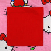 Close up of sewn on pocket, red fabric on a pink t-shirt.