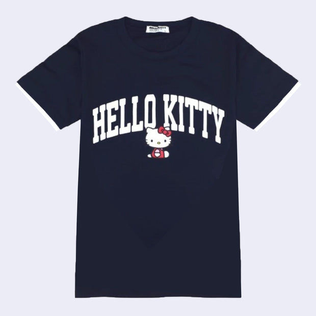 Navy blue jersey t-shirt featuring large text that reads "Hello Kitty" in white capital font, accompanied by a small graphic of a sitting Hello Kitty.