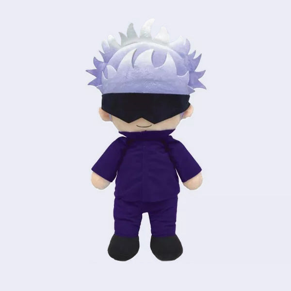 Sitting plush of Gojo from Jujutsu Kaisen with a large head and spiked light purple and white hair. He sits with a smile and a thick blindfold over his eyes.