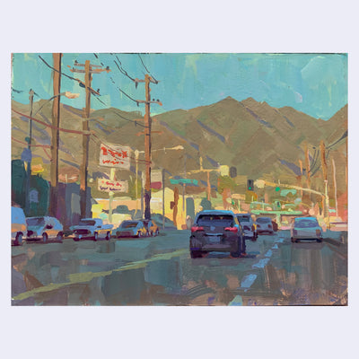 Plein air painting of a city street at sunset, with orange lighting illuminating the background mountains and buildings in the distance and the foreground being shaded. Many cars are parked or driving on the road.