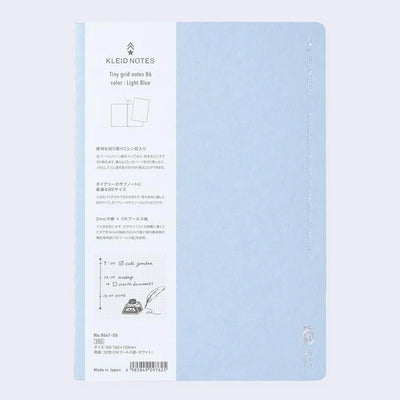 Light blue notebook cover with subtle silver embossed designs and words along the sides.