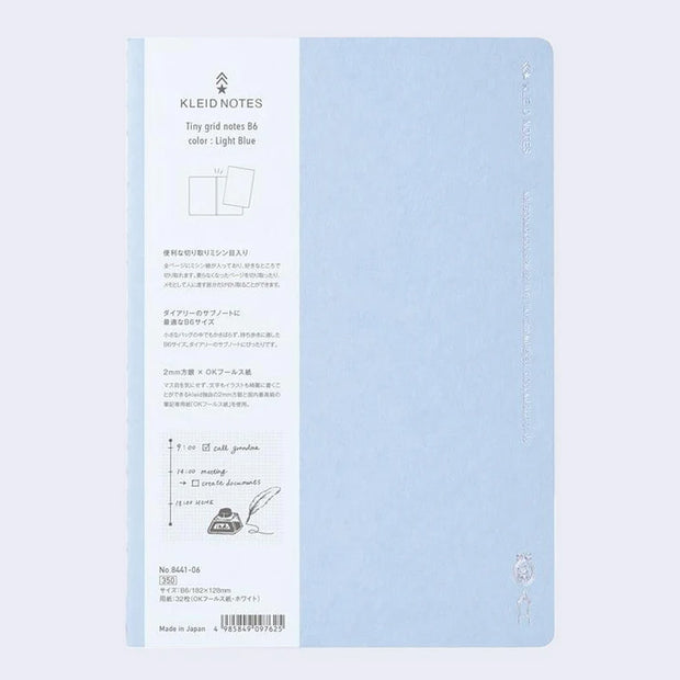 Light blue notebook cover with subtle silver embossed designs and words along the sides.