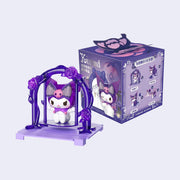 Figure of Kuromi, sitting on a purple swing attached to a purple vine and atop a purple base. She sits in front of her product packaging.