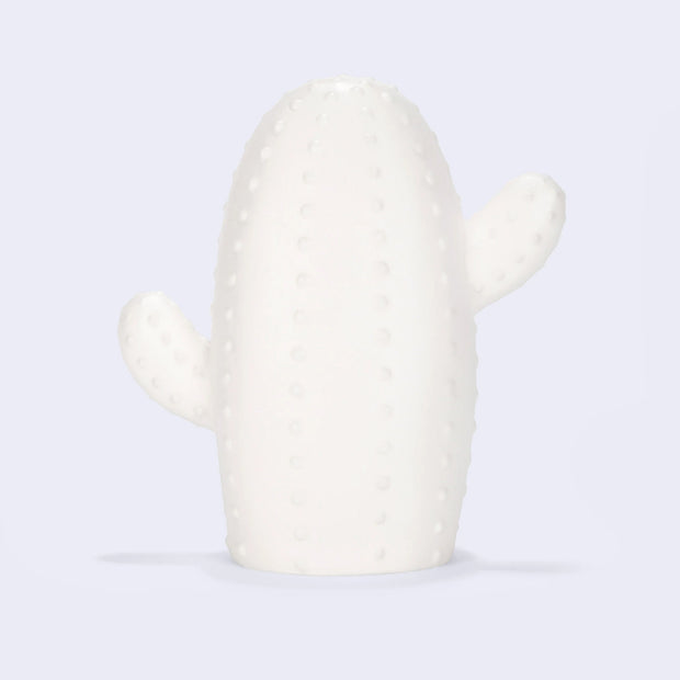 White ceramic lamp in the shape of a cactus with a short and stout body and 2 limbs growing off it. Surface has small dots.