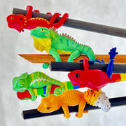 Assortment of 5 different colored and designs of lizards wrapped around a pencil.