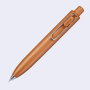 Thick, short dark orange colored pen with a side clip and a silver pen opening.