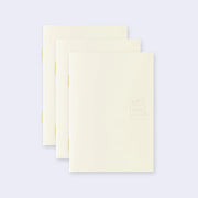 3 cream colored blank notebooks, stacked up on one another.