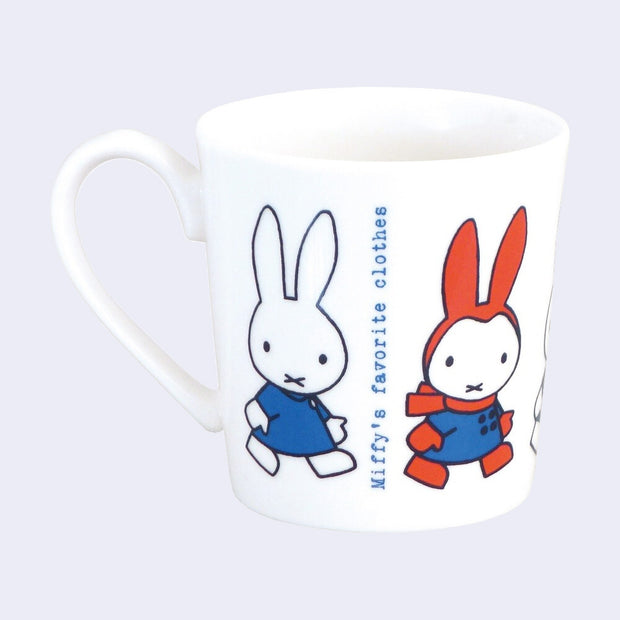 White ceramic mug with illustrations of Miffy, dressed in 2 different outfits and walking to the right. Blue typewriter style text reads "Miffy's favorite clothes"