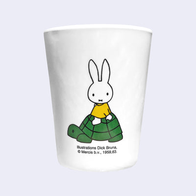 White plastic cup with an illustration of Miffy riding atop of a turtle.