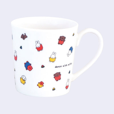 White ceramic mug with many small Miffy and Friends characters, all standing with their arms either extended out or up. Small text reads "dance with miffy".