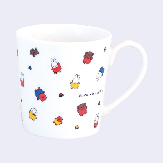 White ceramic mug with many small Miffy and Friends characters, all standing with their arms either extended out or up. Small text reads "dance with miffy".