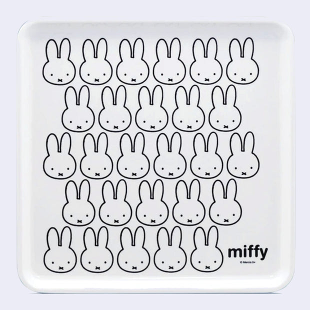 White square tray with a repeating design of Miffy's face, with her small eyes and x shaped mouth. In the lower right corner reads "miffy".