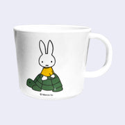 White plastic mug with an illustration of Miffy riding atop of a turtle.