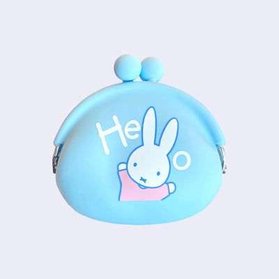 Light blue silicon coin pouch featuring a graphic of Miffy wearing a pink shirt and standing with both her arms up. Above her says "hello" with her 2 ears acting as the 2 l's.