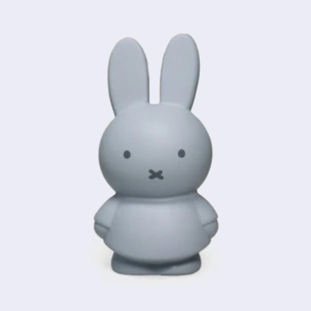 Miffy shaped coin bank, completely colored a silver shade of blue with gray eyes and mouth. She stands wearing a dress with her arms at her sides.