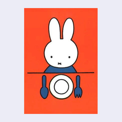 Orangish red background postcard of Miffy sitting at a table with an empty plate and dinner utensils in front of her.