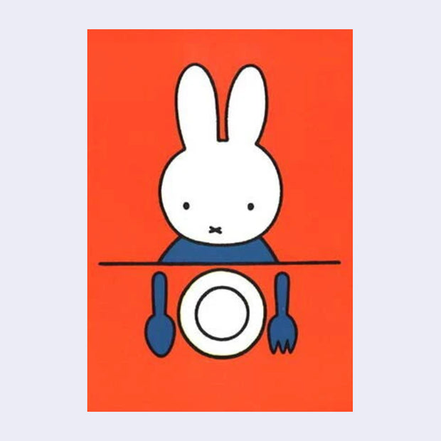 Orangish red background postcard of Miffy sitting at a table with an empty plate and dinner utensils in front of her.