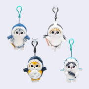 4 keychains of plush cat dolls with large, cute eyes and small mouths. They each wear a shark costume and hold a sea creature, such a seal, a fish, a squid, etc.