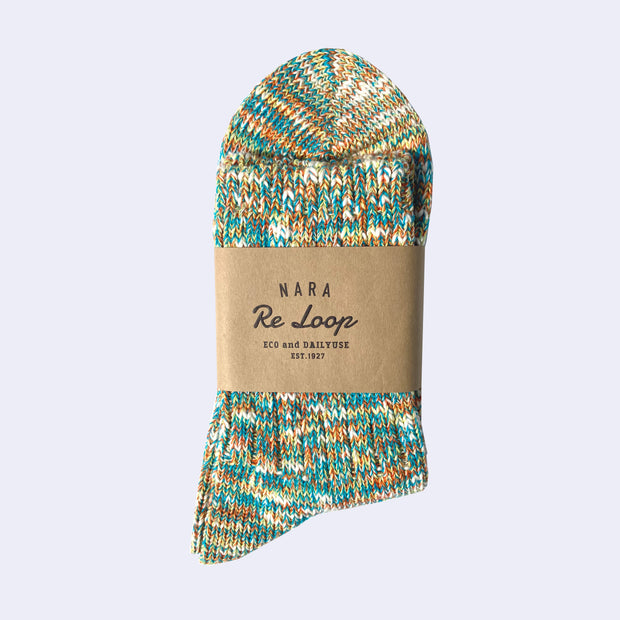 Cotton crew socks thickly knit with green, orange, blue and white thread. Each color is mixed.