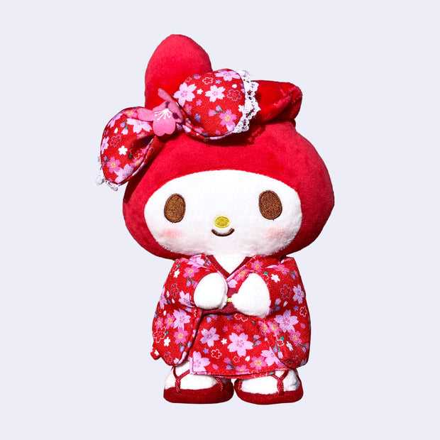 Plush doll of My Melody, dressed in a red kimono with pink cherry blossom pattern design. She has a matching hair bow and red strappy sandals.