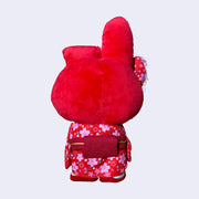 Plush doll of My Melody, dressed in a red kimono with pink cherry blossom pattern design. She has a matching hair bow and red strappy sandals. Back view.