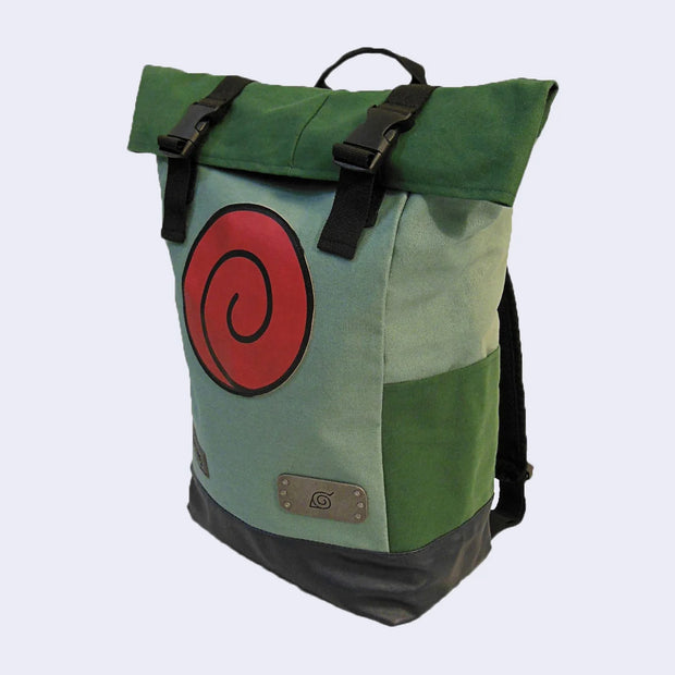 Green roll top canvas backpack with a large red Uzumaki logo on the front and a small metal plaque with the insignia of the Hidden Leaf VIllage from Naruto. It has side pockets and bucket straps up top.