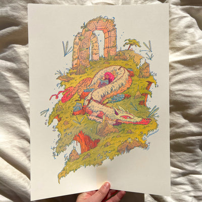 Risograph print of of a large pink dragon, laying on a green hillside with stone arches behind it. A small girl sits resting on the side of the dragon reading a book.