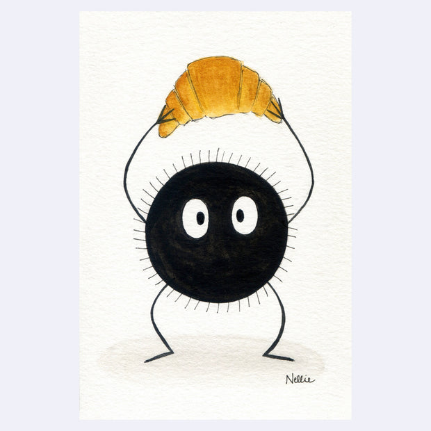 Watercolor illustration of a black soot sprite with large, cute cartoon eyes. It holds a croissant up over its head.