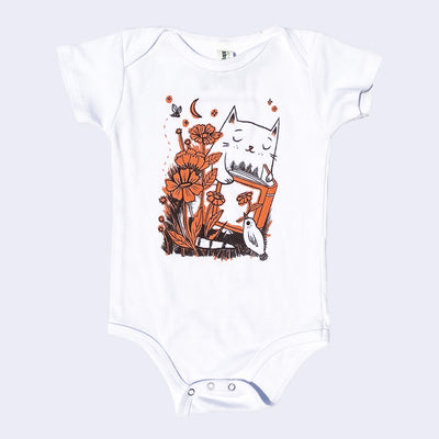 Baby onesie, white fabric with an illustration of a cat reading a book with flowers and a small bird holding a flower in its beak.