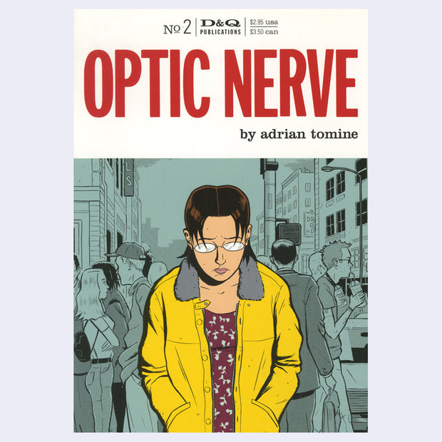 Cover for issue 2 of "Optic Nerve" comic, featuring a cover illustration of a woman with short hair, glasses and a yellow jacket, looking down with her hands in her pockets and a concerned expression. Background is a busy street.