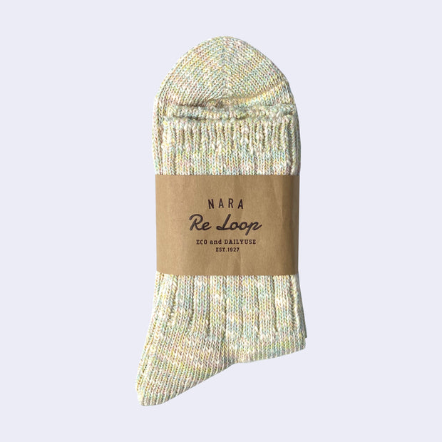 Cotton crew socks thickly knit with pastel green, yellow, pink and white thread. Each color is mixed.