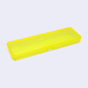 Yellow translucent pencil case with a mint green colored bottom, closed so a slightly greenish yellow color is created.