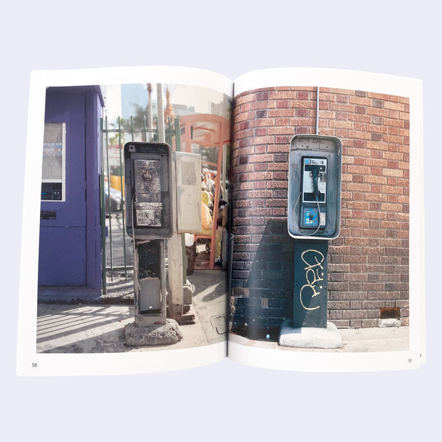 Open book 2 page spread, featuring a photograph on each page of a public telephone stall, mostly graffiti'd with one of the telephones cut off the cord.