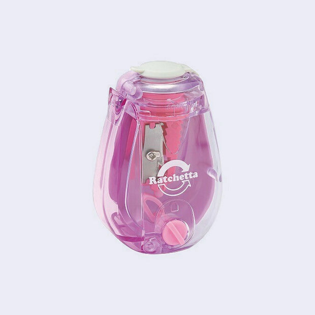 Clear pencil sharpener with a pinkish purple colored interior.