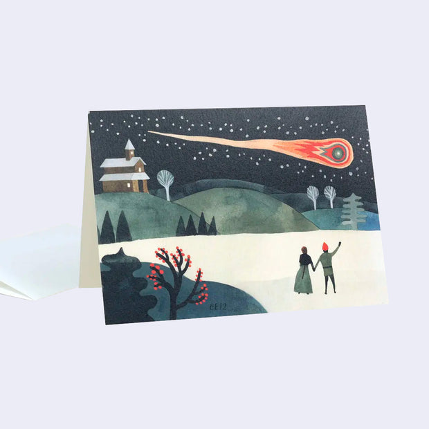 Greeting card with an illustration of a couple standing in the snow, away from many hills and gazing up at a large, fiery shooting star.